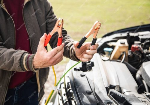 man-stands-front-car-holding-battery-jumper_438099-731.jpg